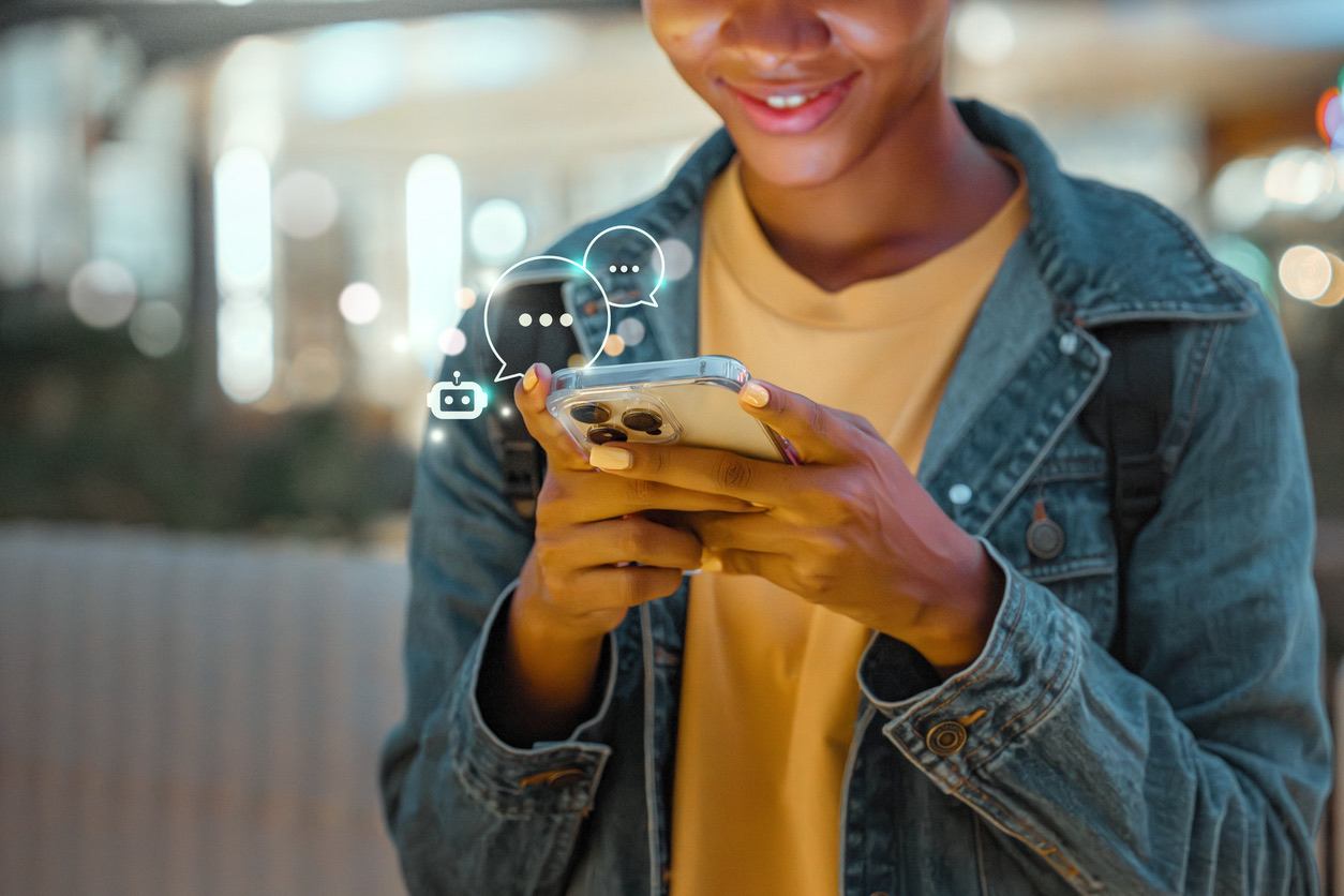 Teenager interacting with chatbot on mobile phone